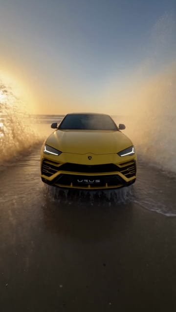 A yellow Lamborghini Urus on a wet beach at sunset changes colour and wheels with each finger snap